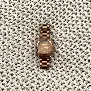 A bronze Michael kors watch in women’s